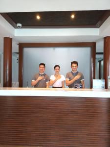 a group of three men standing in front of a mirror at Mandarin White Sand Boracay in Boracay