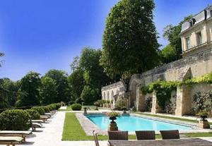 a courtyard with a swimming pool with chairs and a building at Domaine Des Bidaudieres in Vouvray +77 photos