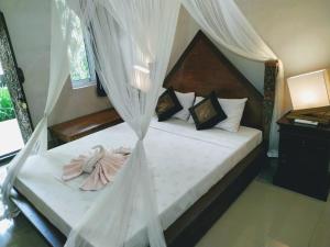 Postel nebo postele na pokoji v ubytování Mandia Bungalows