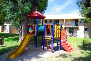a playground with a slide in front of a building at Riverview Holliday villa with River Views and Pool in Kalbarri