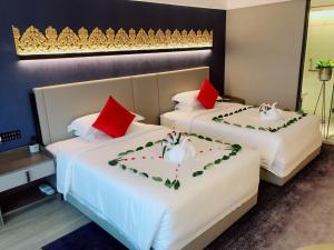 Postel nebo postele na pokoji v ubytování Tian Yi International Hotel 天艺国际酒店