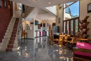 a dining room and kitchen with a table and chairs at StayVista at Lake Trails with Lawn, Balcony & Lake View in Nainital