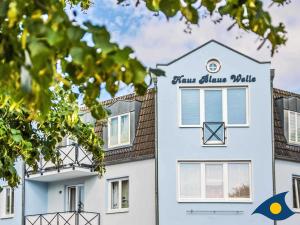 a white building with a sign on it at Blaue Welle Whg 11 "Marius" in Bansin