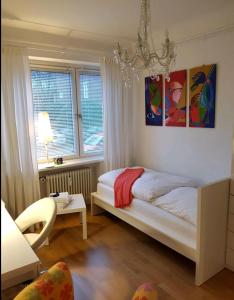 a bedroom with a bed and two paintings on the wall at schönes Privatzimmer in Hamburg Winterhude in Hamburg