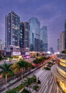 a city skyline with tall buildings and a street at Guangzhou Timmy Hotel in Guangzhou