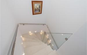 a glass staircase with a picture on the wall at 2 Bedroom Gorgeous Home In Krk in Krk