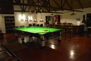 a pool table in the middle of a room at Red Earth Kabini in Begūr