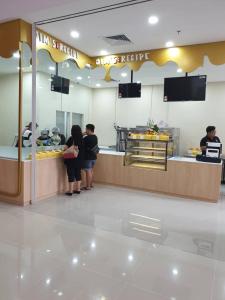 a group of people standing at a counter in a restaurant at Country garden danga bay ,bay point in Johor Bahru +64 photos