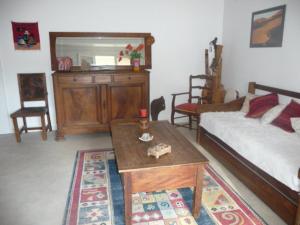 a bedroom with a bed and a table and a mirror at Gîte "Chante' Relle" in Privas