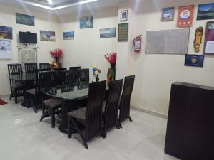 a dining room with a table and chairs at Hotel Hillora Mcleodganj in McLeod Ganj