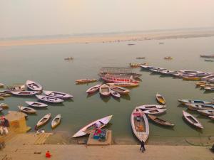 a group of boats are parked in the water at Maa Durga Inn in Varanasi