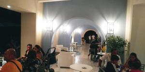 a group of people sitting at tables in a restaurant at Borgo Marino Albatros in Zambrone