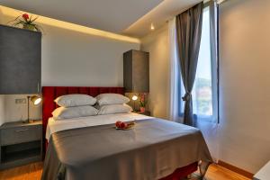 a bedroom with a large bed and a window at Hotel M in Podgorica