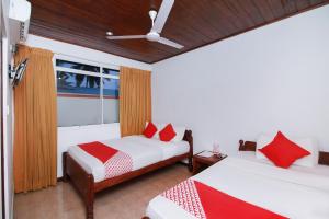 a bedroom with two beds and a window at Hotel Aradhana in Galle +23 photos