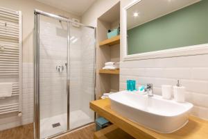 a bathroom with a sink and a shower at aqualago casa vacanze apartment E in Verbania