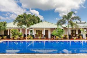 a villa with a swimming pool in front of a house at Atara Lagoon Kalpitiya in Kalpitiya