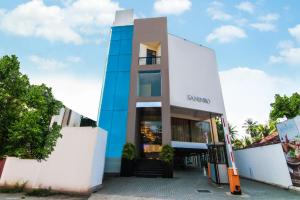 a building with the entrance to a store at Saninro Hotel - Ragama in Ragama