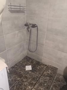 a shower in a bathroom with a tile wall at YourHostel Club in Kyiv