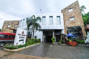 a white building with a sign in front of it at Grand Rockland Hotel in Matara