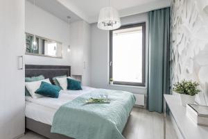 A bed or beds in a room at NavyGroup - NaviFlat Apartament Brabank
