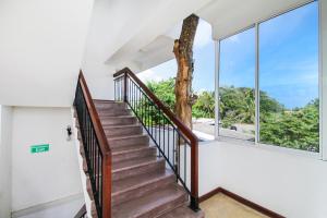 a staircase in a house with large windows at Arken Lanka in Galle +24 photos