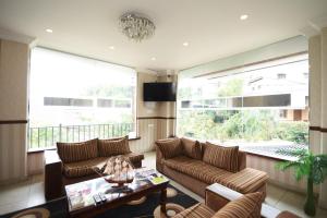 a living room with two couches and a tv at Galaxy City Hotel in Kandy