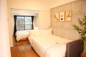 Uma cama ou camas num quarto em Yoshitsuki kaku - Yoshitsuki Apart Hotel