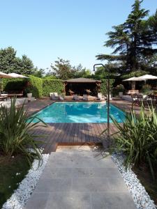 a swimming pool in a yard with a patio at Le Cèdre de Soyons in Soyons