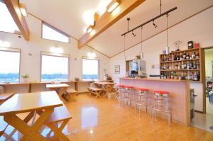 a restaurant with tables and chairs and a bar at Polaris in Teshikaga