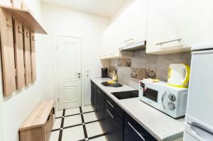 a kitchen with a microwave and a sink at Wonderful flat on city center (Mukachivska 4/21) in Uzhhorod