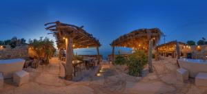 a restaurant on the beach at night at Aigialis Apartments & Studios in Kokkini Khanion