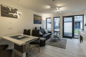 a kitchen and living room with a table and a couch at Ankerplatz in Büsum