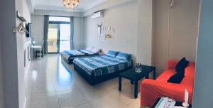 a living room with two beds and a couch at Chu House in Donggang +25 photos