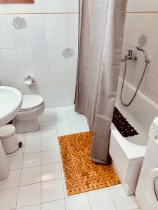 a bathroom with a shower and a toilet and a sink at Vravrona Family House in Artemida +35 photos