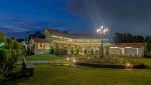 a building with a street light in a yard at night at Fiestaa Resort n Events Venue in Devanahalli-Bangalore