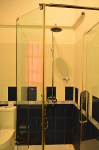 a bathroom with a glass shower with a toilet at Marina Bentota in Bentota