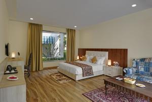 a hotel room with a bed and a couch at Clarks Safari Ranthambore in Khilchipur