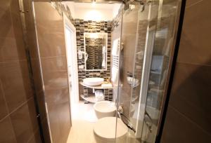 a bathroom with two sinks and a glass shower at Playa del Mar - Adults Only in Monopoli