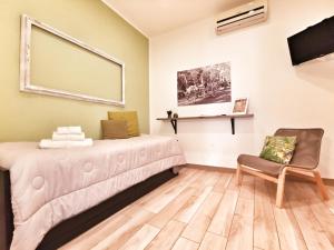 a room with a bed and a chair at A Palermo Sono in Palermo