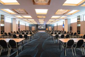 a room with tables and chairs in a room with ceilings at Hotel International in Sinaia