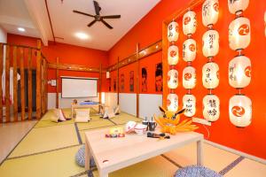 a room with orange walls and a table with paper lanterns at Manhattan Theme Suite by Nest Home at Austin Heights in Johor Bahru