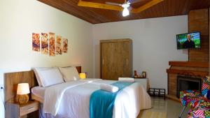 A bed or beds in a room at Pousada Sitio do Visconde