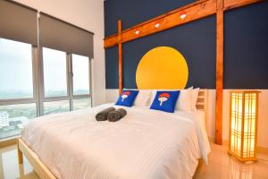 a bedroom with a large bed with a yellow and blue wall at Manhattan Theme Suite by Nest Home at Austin Heights in Johor Bahru
