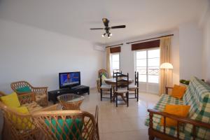 a living room with a couch and chairs and a table at Carob By Algartur in Santa Luzia