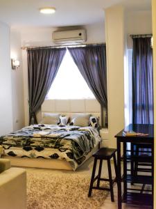 a bedroom with a bed with a large window at Marilyn Studio with Sea View Wi Fi in Hurghada