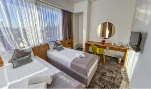 Krevet ili kreveti u jedinici u objektu Orange Hotel