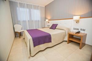Postel nebo postele na pokoji v ubytování Hotel Teruel