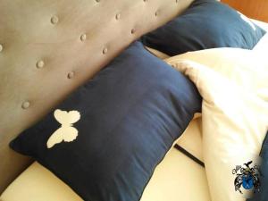 a bed with a pillow with a mouse on it at Villa Cheval in Aukštadvaris