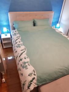 a bed with a white bedspread with plants on it at Apartman KEJ BLUE free parking in Kraljevo