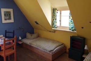 Schlafzimmer mit einem Bett, einem Fenster und einem Tisch in der Unterkunft Ferien im Denkmal an der Elbe in Stadt Wehlen
